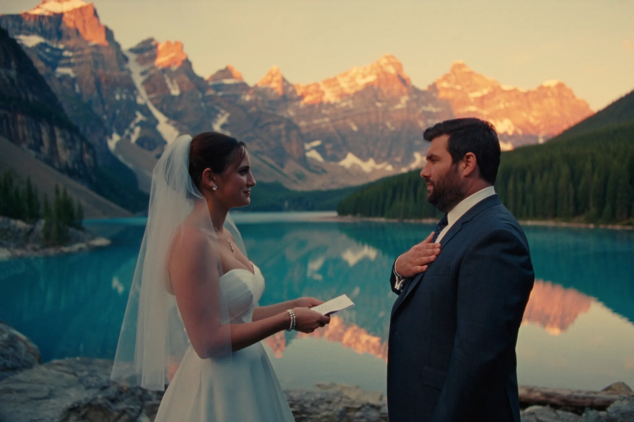 A couple at a sunrise ceremony on the shore of Moraine Lake