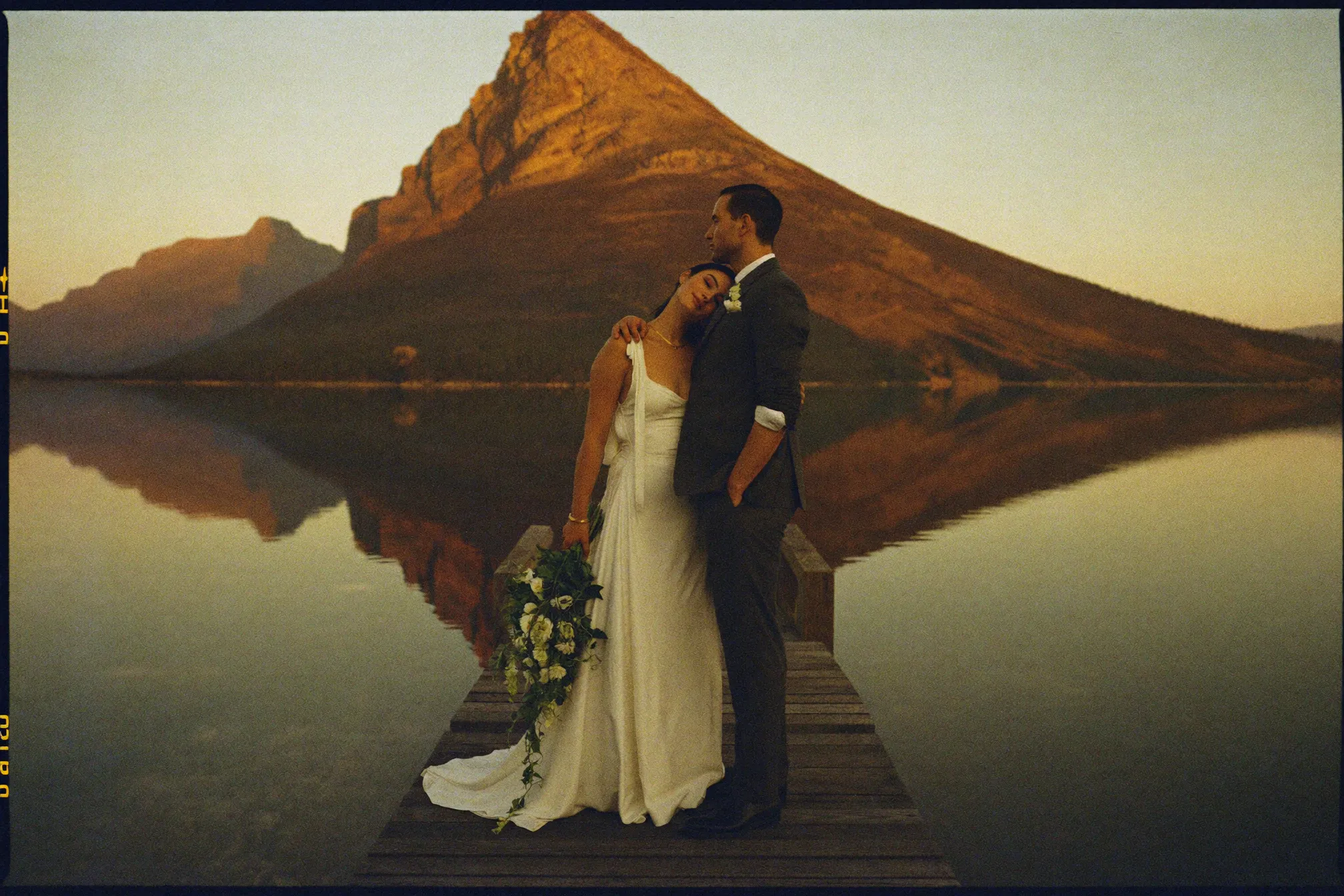 A couple at Maligne Lake in Jasper at dawn with Spirit Island behind them