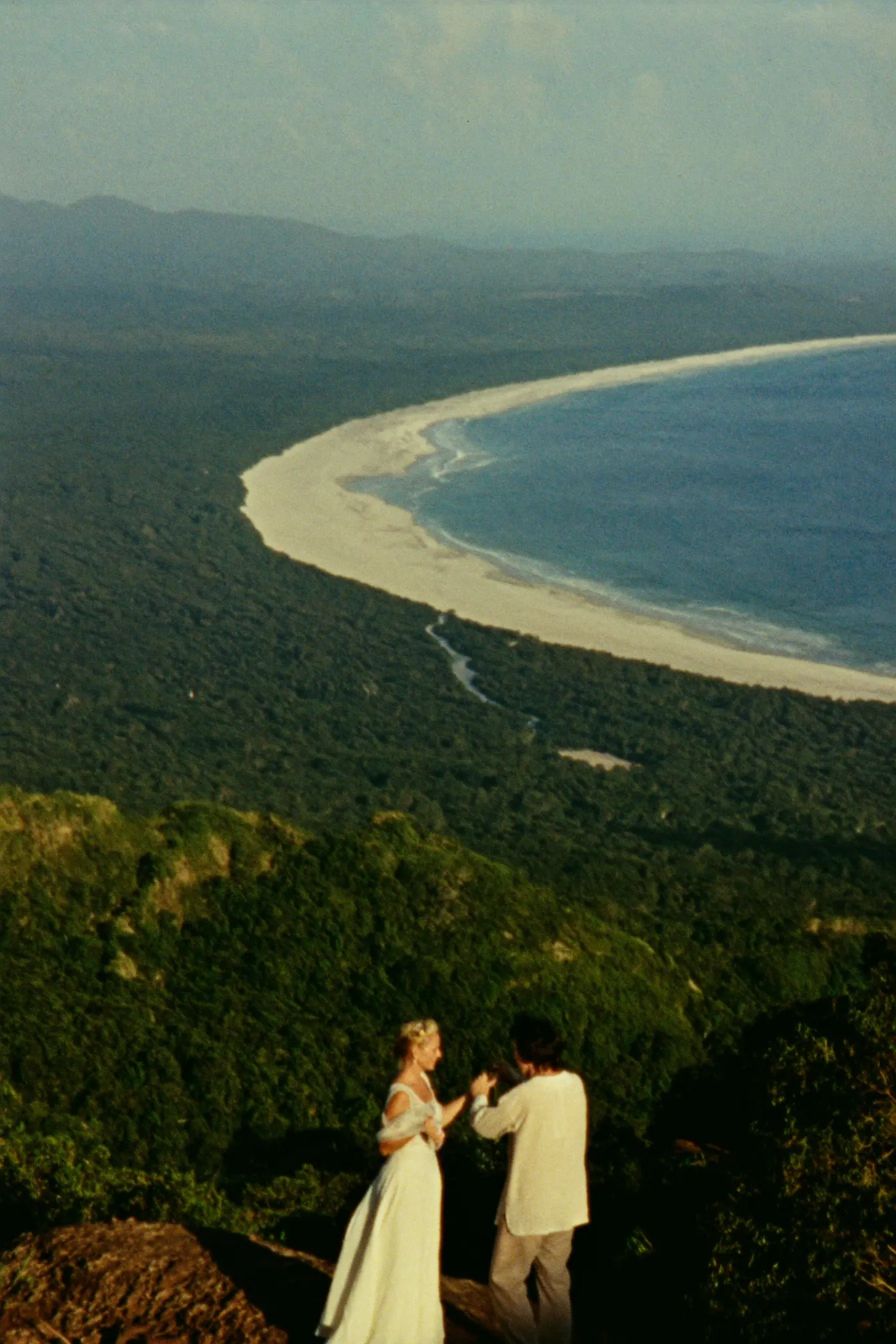 A couple eloping above the Whale's Tail sandbar at Uvita, Costa Rica