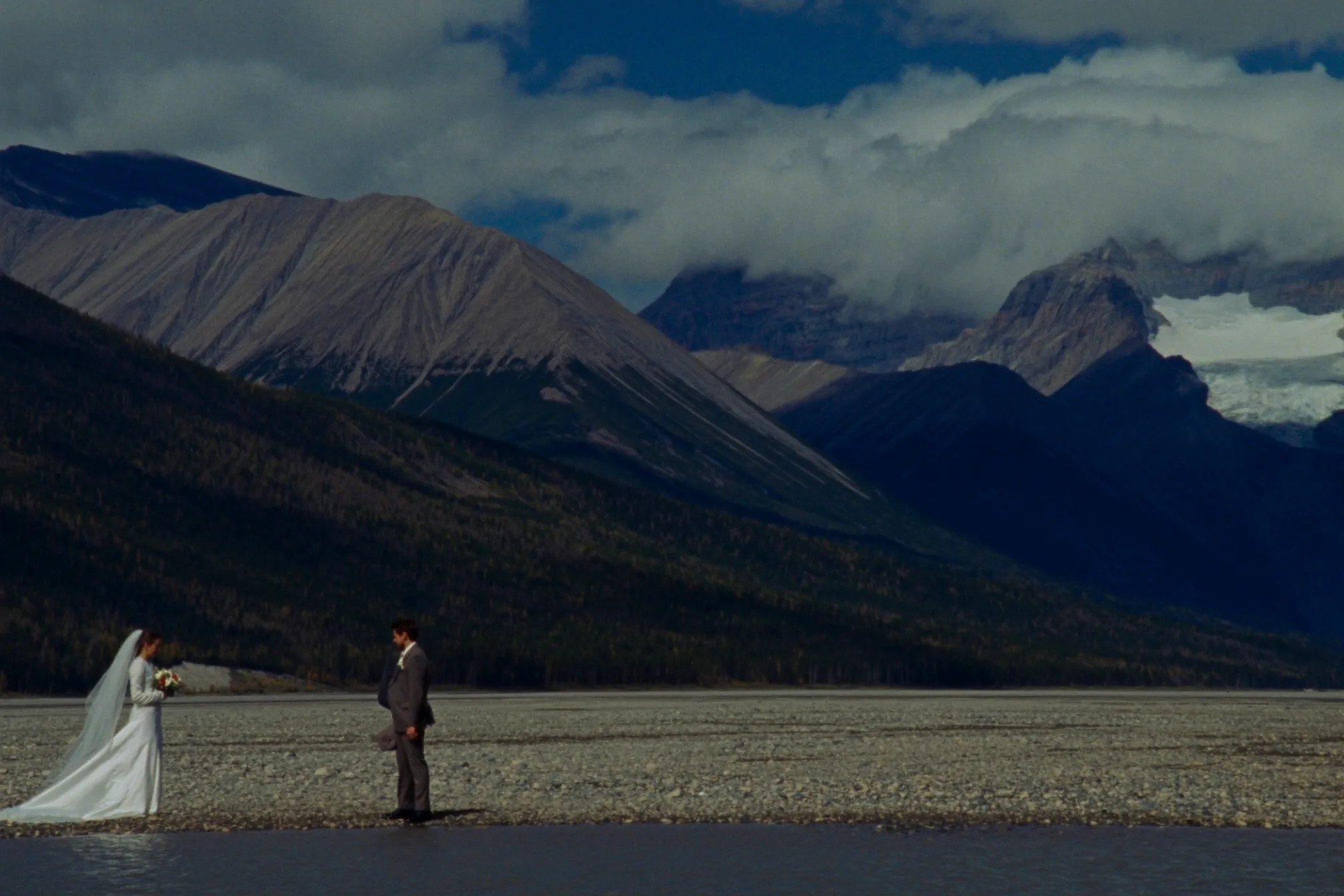 A couple eloping by a glacial lake in Jasper National Park