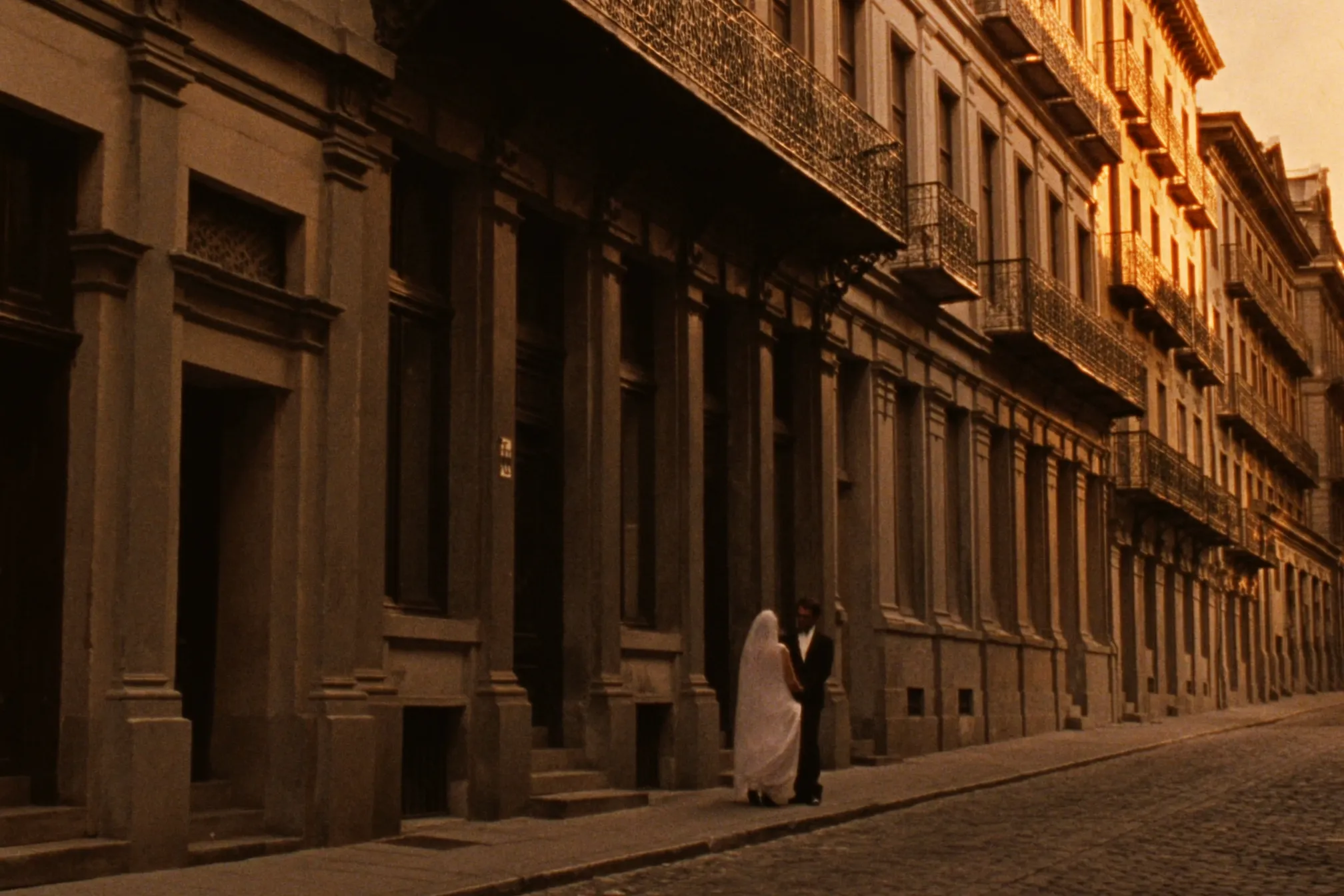 A couple eloping on the cobblestone streets of Old Montreal at golden hour