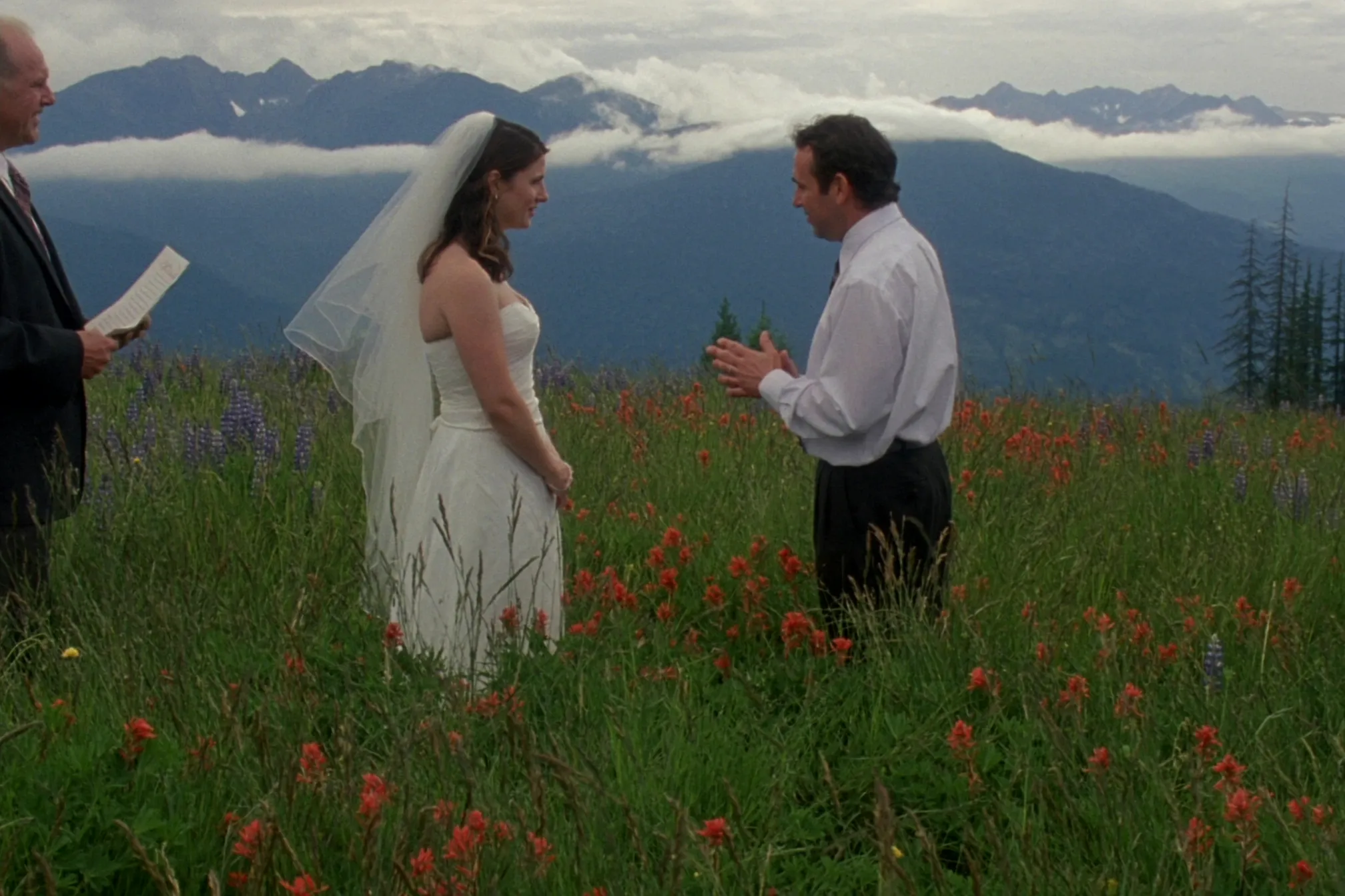 A couple exchanging vows in an alpine wildflower meadow above Revelstoke