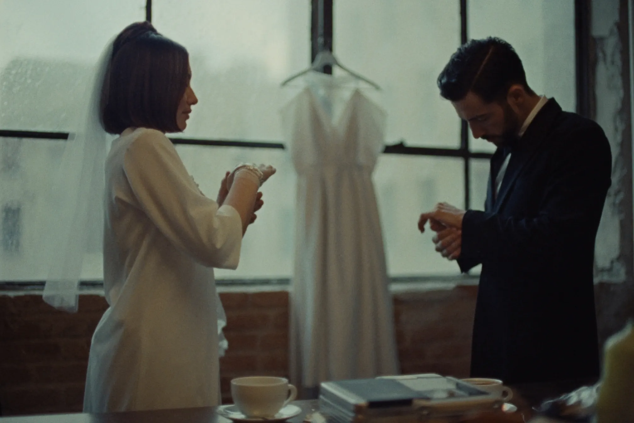 A couple getting ready in a light-filled Gastown loft at dawn
