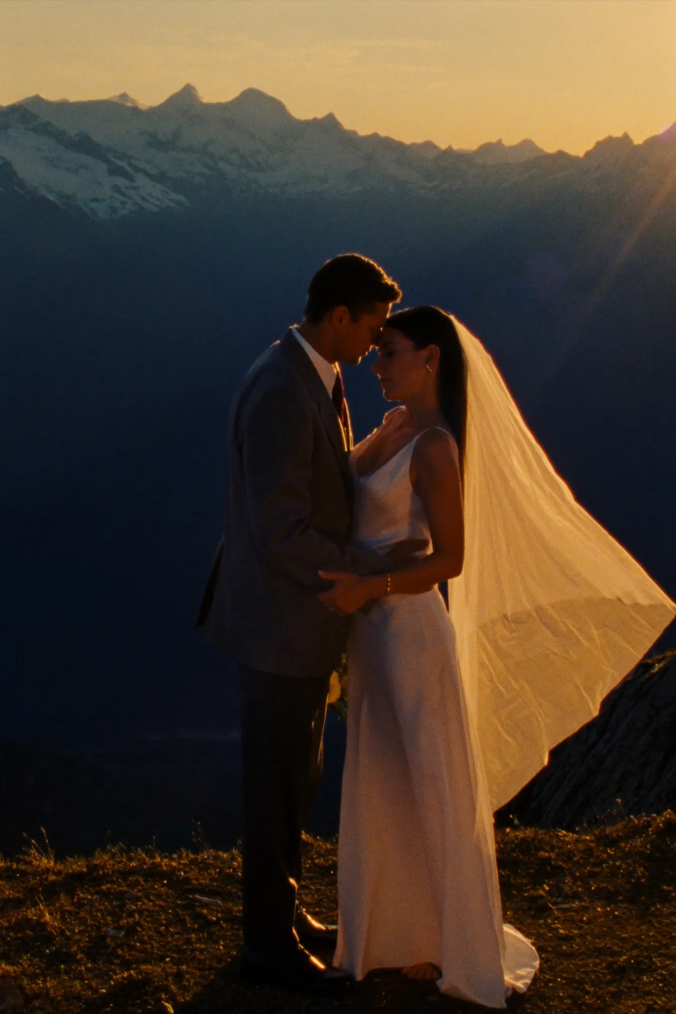 A couple on a Whistler alpine ridge at golden hour