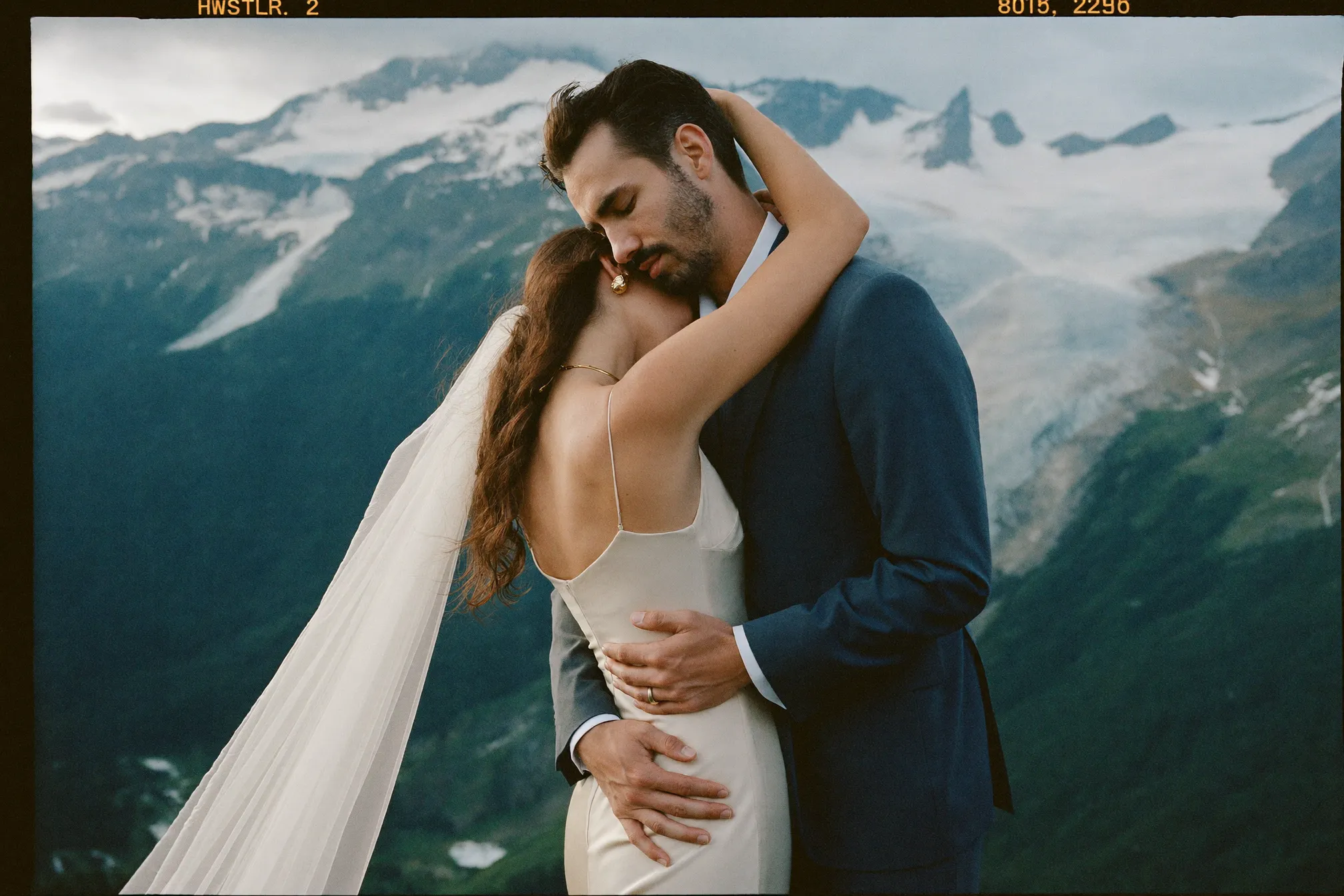 A couple exchanging vows on the alpine platform with glaciers behind